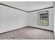 Neutral carpeted bedroom featuring a window with a view of the outdoors at 66 Privette Way, Zebulon, NC 27597