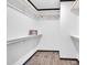 Walk-in closet with built-in shelving and laminate wood flooring at 66 Privette Way, Zebulon, NC 27597