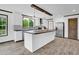 Spacious kitchen featuring a center island, pendant lighting, white cabinetry, and modern stainless appliances at 66 Privette Way, Zebulon, NC 27597