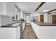 Bright kitchen with white cabinetry, a center island, and a stainless steel refrigerator at 66 Privette Way, Zebulon, NC 27597