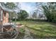 Large backyard with a grassy lawn and access to the home's back entrance at 704 N King Charles Rd, Raleigh, NC 27610