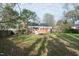 Spacious backyard featuring a lush lawn and mature trees at 704 N King Charles Rd, Raleigh, NC 27610