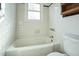 Bathroom with a tub, toilet, and black and white tiling at 704 N King Charles Rd, Raleigh, NC 27610