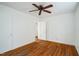 Bedroom featuring gleaming hardwood floors, ceiling fan, and fresh neutral paint at 704 N King Charles Rd, Raleigh, NC 27610