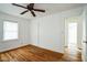 Bedroom features hardwood floors, white walls, a ceiling fan, and closet at 704 N King Charles Rd, Raleigh, NC 27610