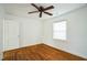 Bright bedroom with hardwood floors, a ceiling fan, and natural light from window at 704 N King Charles Rd, Raleigh, NC 27610