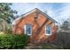 Rear exterior brick home showing gable roof with yard and some landscaping at 704 N King Charles Rd, Raleigh, NC 27610