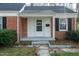 Close-up of the home's front door and facade detailing brick and architectural features at 704 N King Charles Rd, Raleigh, NC 27610