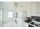 Open kitchen showcasing bright white cabinets, appliances, and a tiled floor with a fan at 704 N King Charles Rd, Raleigh, NC 27610