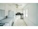 Well-lit kitchen featuring white cabinets, modern appliances, and a classic tile floor at 704 N King Charles Rd, Raleigh, NC 27610