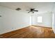 Sunlit living room featuring hardwood floors, ceiling fan, and neutral white walls at 704 N King Charles Rd, Raleigh, NC 27610