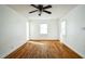 Empty Living Room with natural light featuring hardwood floors, neutral white walls and a fan at 704 N King Charles Rd, Raleigh, NC 27610