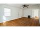 Bright living room with hardwood floors, white walls, and a ceiling fan at 704 N King Charles Rd, Raleigh, NC 27610