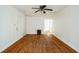 Open living room with hardwood floors, white walls, ceiling fan, and front door at 704 N King Charles Rd, Raleigh, NC 27610