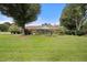 Expansive backyard with a well-maintained lawn and mature trees, creating a private outdoor retreat at 705 N Gurney St, Burlington, NC 27215