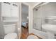 This bathroom includes white cabinets for storage and a shower with sliding doors right off the bedroom at 705 N Gurney St, Burlington, NC 27215