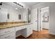 Well-lit bathroom featuring a vanity with stone countertops and wood floors at 705 N Gurney St, Burlington, NC 27215