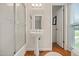 This bathroom features a pedestal sink and a walk-in shower with glass doors along with great natural light at 705 N Gurney St, Burlington, NC 27215