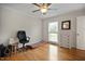 This bright bedroom features hardwood floors, a ceiling fan, and natural light from a large window at 705 N Gurney St, Burlington, NC 27215