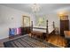 Comfortable bedroom with a four-poster bed, chandelier, and large dresser at 705 N Gurney St, Burlington, NC 27215
