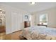 Cozy bedroom featuring hardwood floors, closet space, a window for natural light and a quaint writing desk at 705 N Gurney St, Burlington, NC 27215