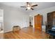 This bedroom includes hardwood floors, a ceiling fan, closet, and an additional wooden cabinet for storage at 705 N Gurney St, Burlington, NC 27215