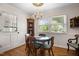 Cozy breakfast nook with wood table set, chandelier, and natural light from window at 705 N Gurney St, Burlington, NC 27215