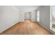 Bright empty room with light wood floors and natural light streaming through the windows at 705 N Gurney St, Burlington, NC 27215
