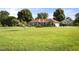 Sprawling one-story brick home featuring a lush lawn and mature trees in a serene setting at 705 N Gurney St, Burlington, NC 27215