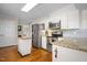 Well-lit kitchen with stainless steel appliances, granite countertops, and ample cabinet space at 705 N Gurney St, Burlington, NC 27215
