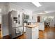 Bright kitchen featuring stainless steel appliances, white cabinets, and hardwood floors at 705 N Gurney St, Burlington, NC 27215