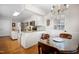 Bright kitchen area open to a breakfast nook and featuring stainless steel appliances and white cabinets at 705 N Gurney St, Burlington, NC 27215