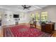 Bright living room with custom built-ins, ceiling fan, and views of landscaped yard at 705 N Gurney St, Burlington, NC 27215
