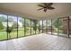 Spacious screened porch with tile flooring, offering views of the landscaped backyard and outdoor living space at 705 N Gurney St, Burlington, NC 27215