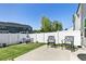 Spacious backyard with a concrete patio, white fence, and comfortable outdoor seating at 713 Putney Hill Rd, Zebulon, NC 27597