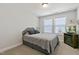 Well-lit bedroom with a cozy bed, sleek headboard, and a television with a fireplace underneath at 713 Putney Hill Rd, Zebulon, NC 27597