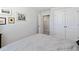 Bright bedroom with a comfortable bed, decorative artwork, and a doorway to the hallway at 713 Putney Hill Rd, Zebulon, NC 27597
