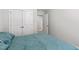 Comfortable bedroom showcasing a well-made bed, neutral walls, and a view into the hallway at 713 Putney Hill Rd, Zebulon, NC 27597