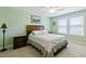 Relaxing bedroom features a neutral carpet, large bed, and natural light from the windows at 713 Putney Hill Rd, Zebulon, NC 27597