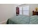 Comfortable bedroom featuring large windows, an elegant dresser, and unique decor for a stylish look at 713 Putney Hill Rd, Zebulon, NC 27597