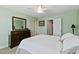 Comfortable bedroom boasts a ceiling fan, dresser, and easy access to the ensuite bathroom at 713 Putney Hill Rd, Zebulon, NC 27597