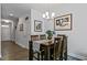 Stylish dining area with a wooden table, seating for four, and elegant light fixture at 713 Putney Hill Rd, Zebulon, NC 27597