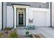 Inviting front entrance with a decorative wreath, charming bench, and a well-lit doorway at 713 Putney Hill Rd, Zebulon, NC 27597