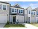 Beautiful townhome exterior with stone accents, an attached garage, and a lovely front garden at 713 Putney Hill Rd, Zebulon, NC 27597