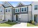 Exterior view of a modern townhome featuring a one-car garage and neatly landscaped front yard at 713 Putney Hill Rd, Zebulon, NC 27597