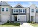 Charming townhome showcasing a well-manicured lawn, attached garage and a welcoming front door at 713 Putney Hill Rd, Zebulon, NC 27597