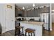 Open kitchen with a granite island, stainless steel appliances, and chic gray cabinets at 713 Putney Hill Rd, Zebulon, NC 27597