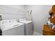 Functional laundry room equipped with a washer, dryer, and convenient overhead shelving for storage at 713 Putney Hill Rd, Zebulon, NC 27597