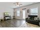 Inviting living room with wood flooring, gray sofa, and access to the backyard at 713 Putney Hill Rd, Zebulon, NC 27597