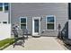 Concrete patio area with outdoor seating and a convenient back door access at 713 Putney Hill Rd, Zebulon, NC 27597